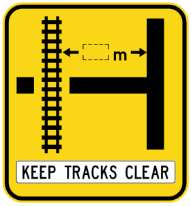 W7-12-3n(L) - Rail Crossing On Side Road (symbolic - 'T' junction Left) Keep Tracks Clear