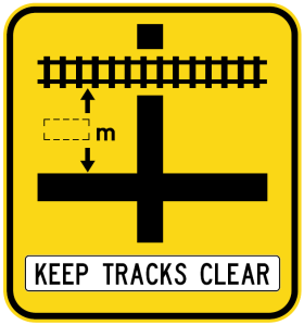 W7-13-2n - Rail Crossing On Side Road (symbolic - 'Cross' junction) Keep Tracks Clear