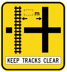 W7-13-2n(L) - Rail Crossing On Side Road (symbolic - 'Cross' junction Left) Keep Tracks Clear